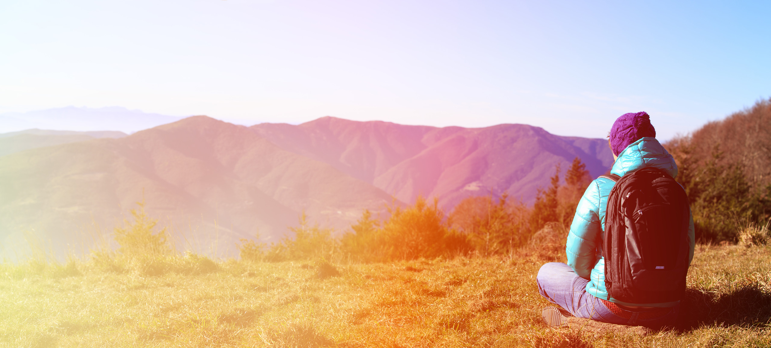 Woman with backpack meditating in mountains. Need to clear your head? Take a hike!